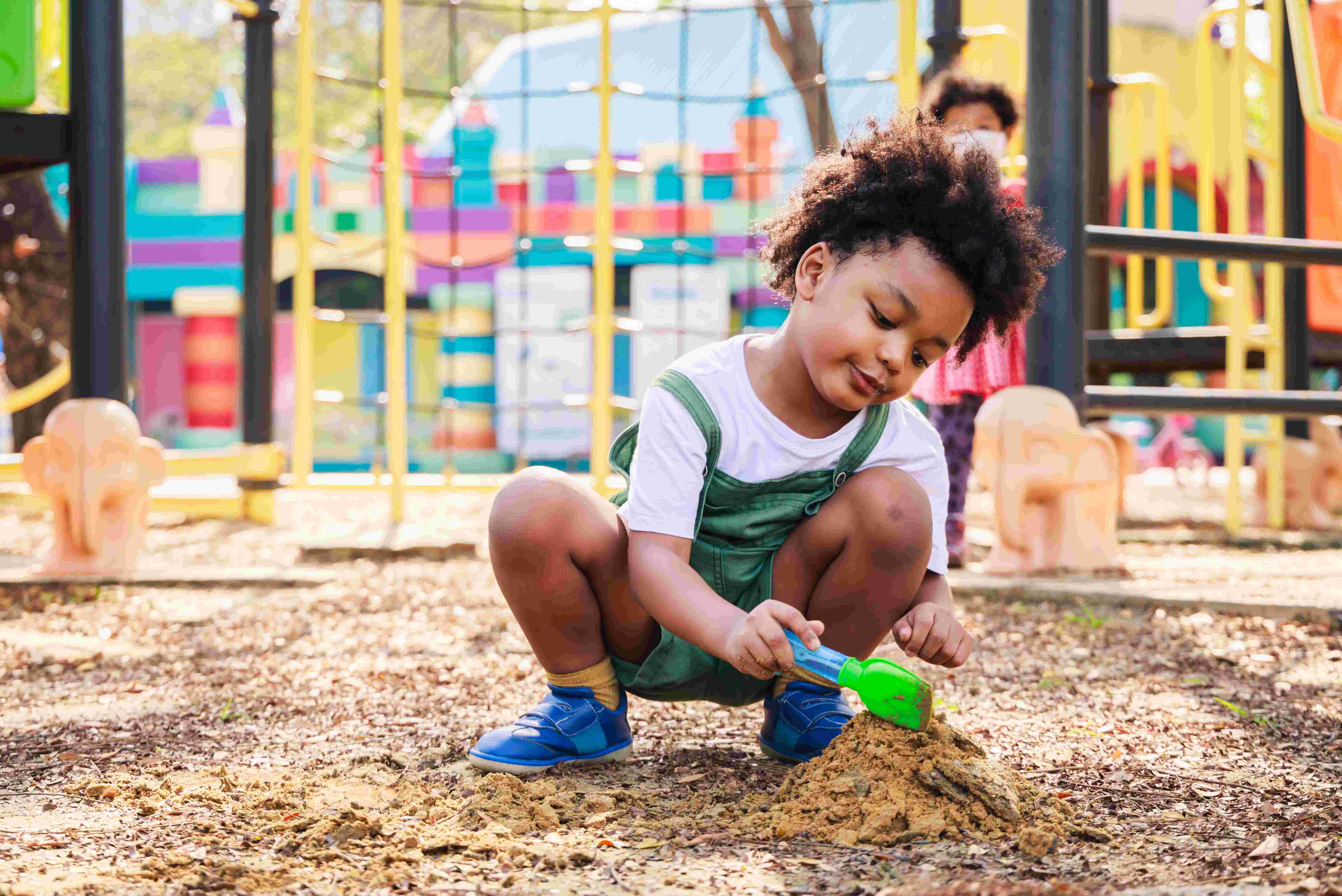 kid playing in sand
